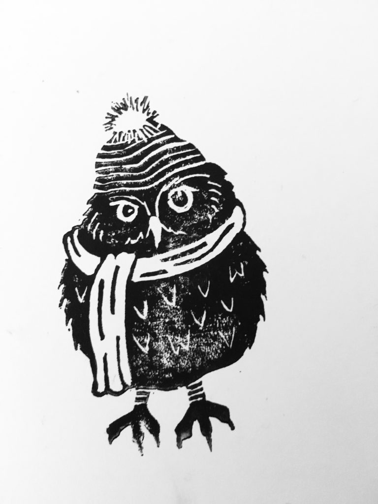 A print of an owl wearing a scarf