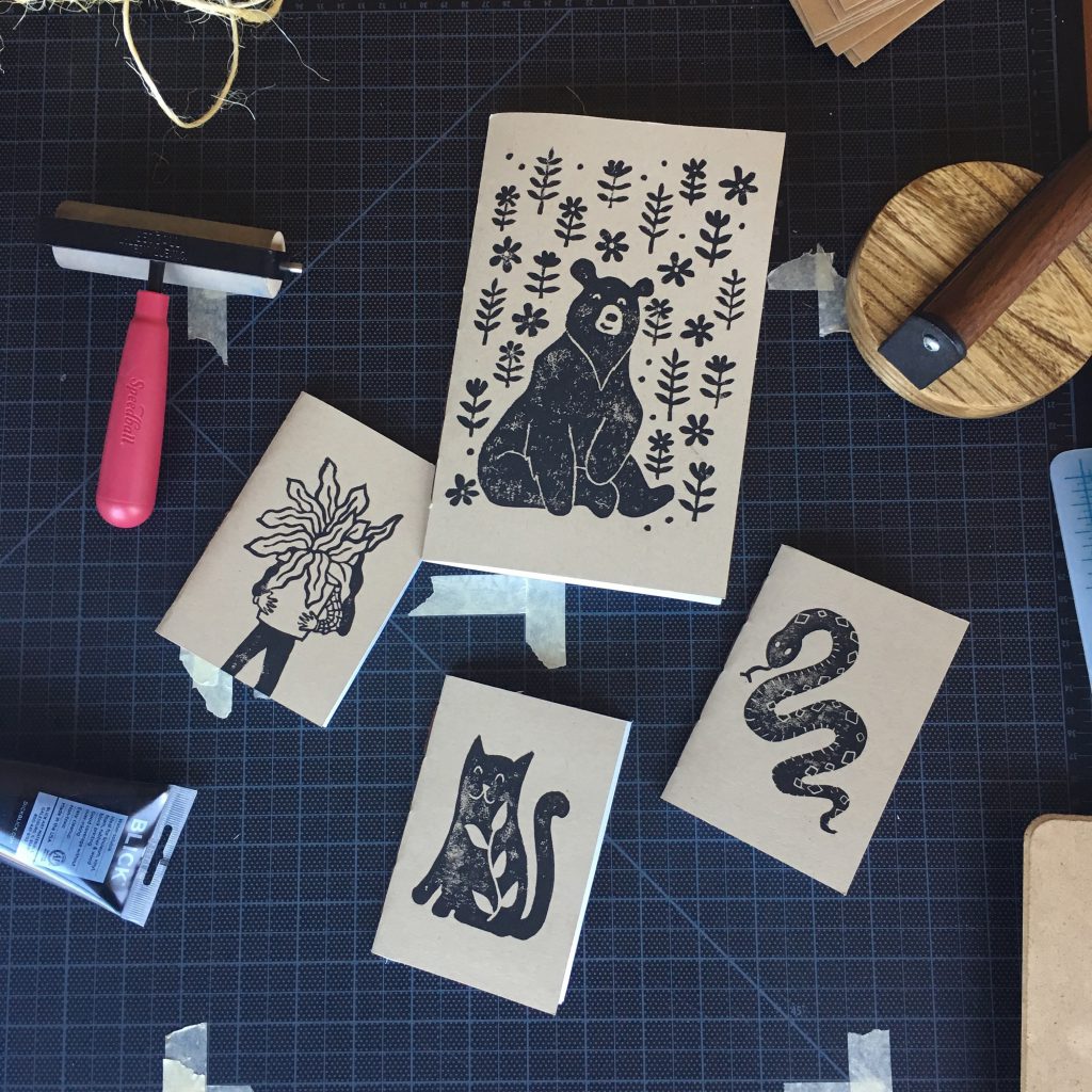 A collection of handprinted notebooks and printing tools