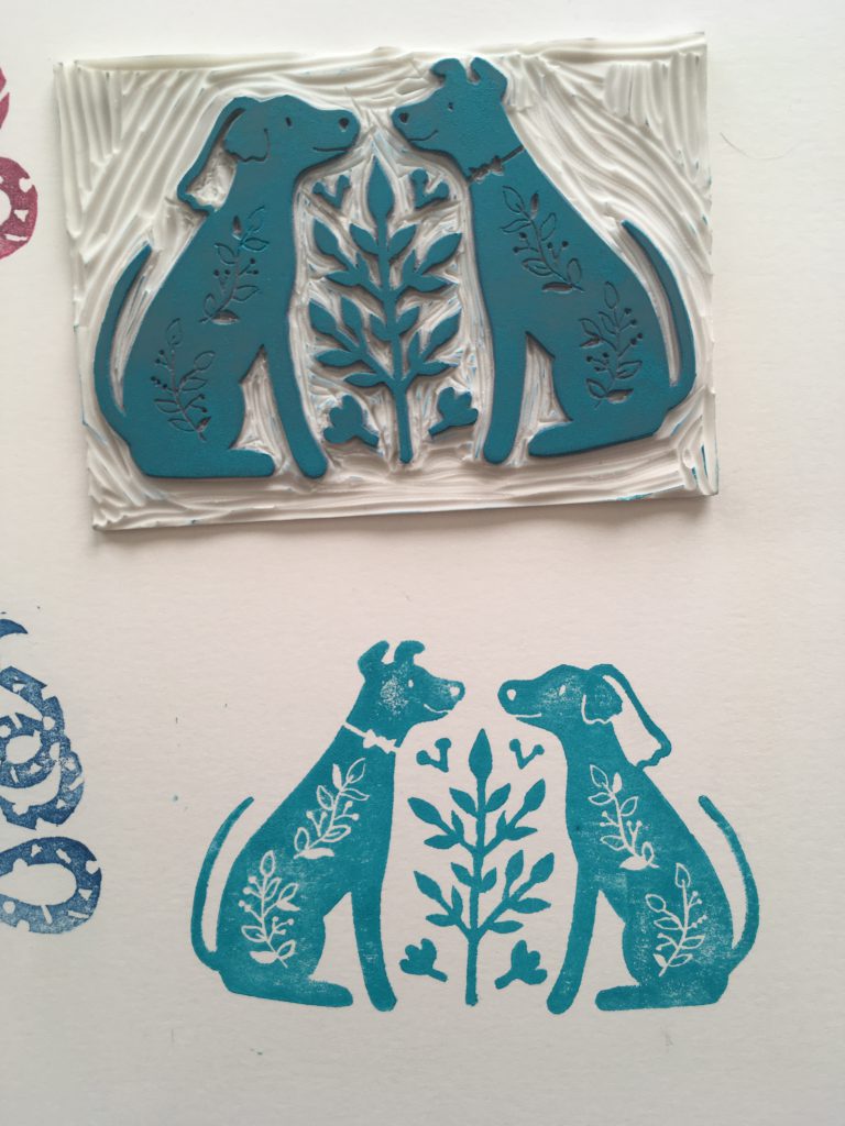 A carved stamp of two dogs in love