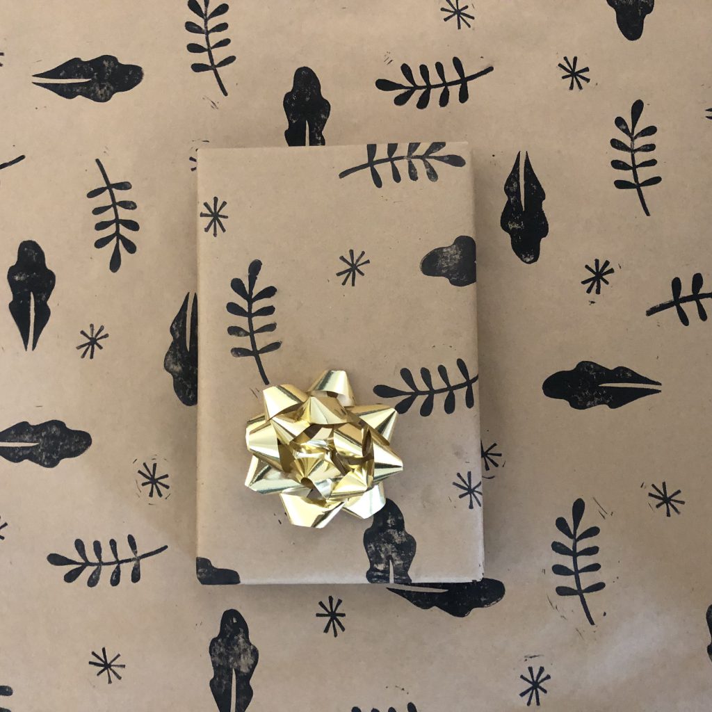 A gift wrapped in hand printed wrapping paper