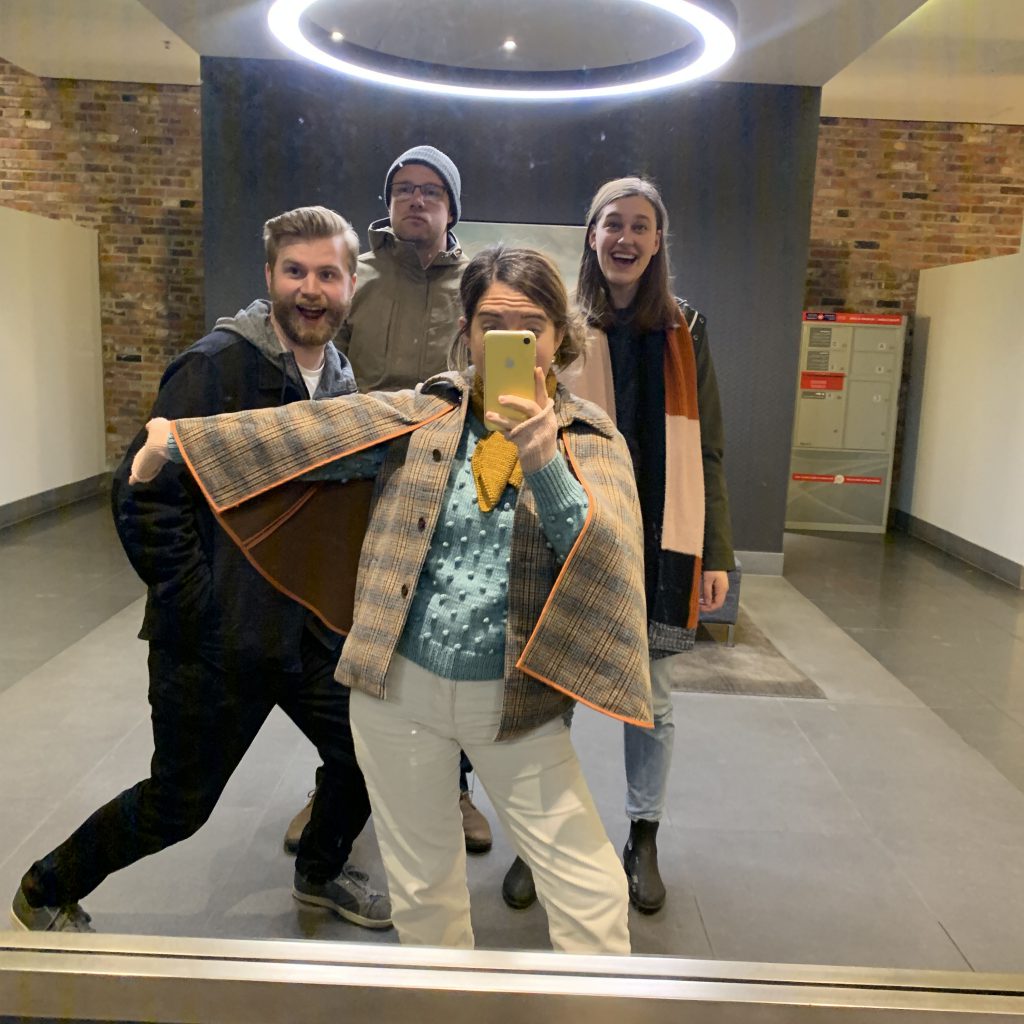 A group of friends posing for a silly mirror selfie