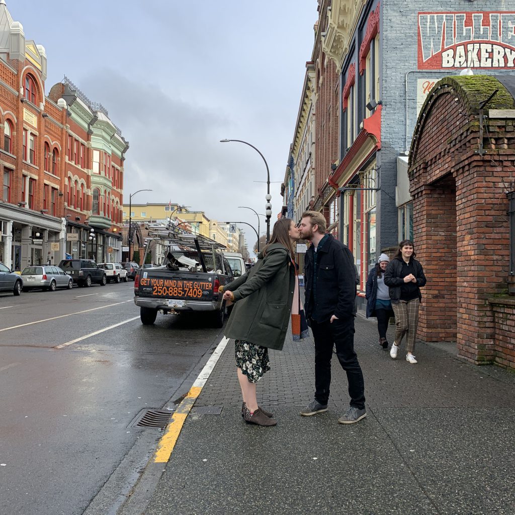 Kaila and Ian share a kiss on the streets of Victoria, BC