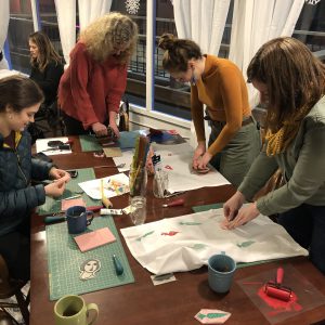 A group of people learning how to block print