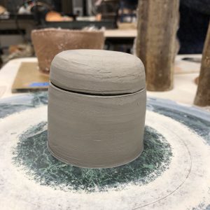A lidded jar made of clay