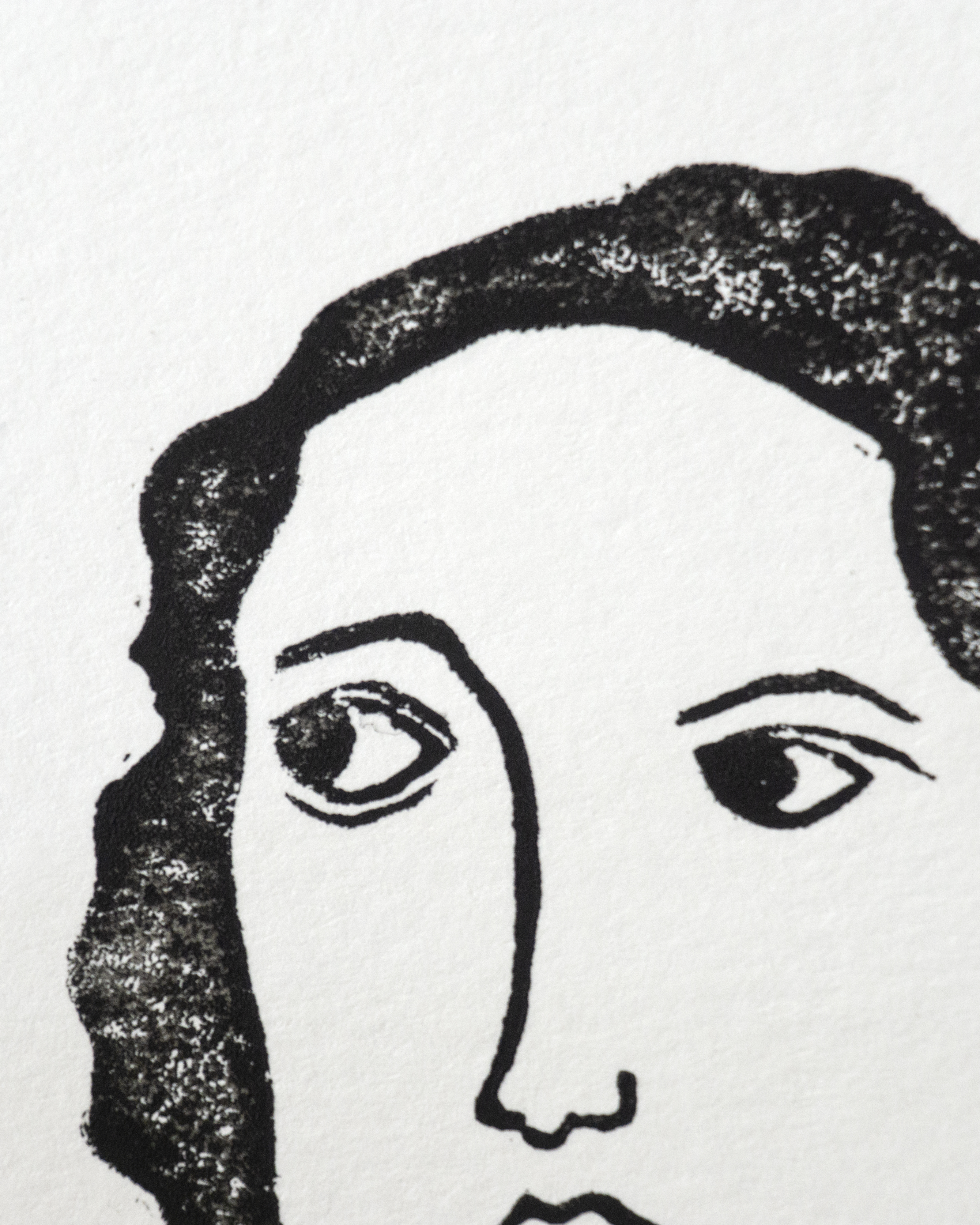 A closeup of a linocut print of a woman's face