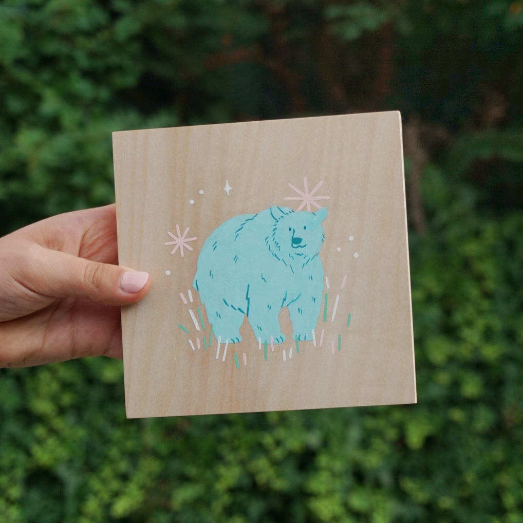A gouache painting of a blue bear on a wood panel canvas