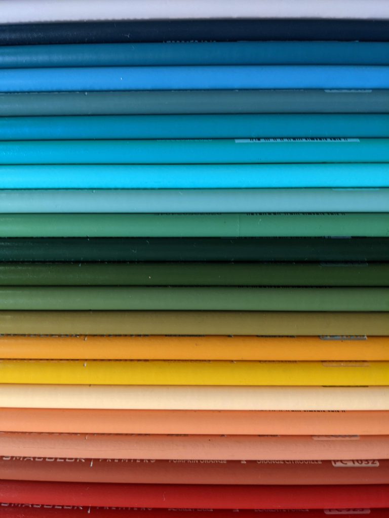 A rainbow of colored pencils all lined up neatly next to each other